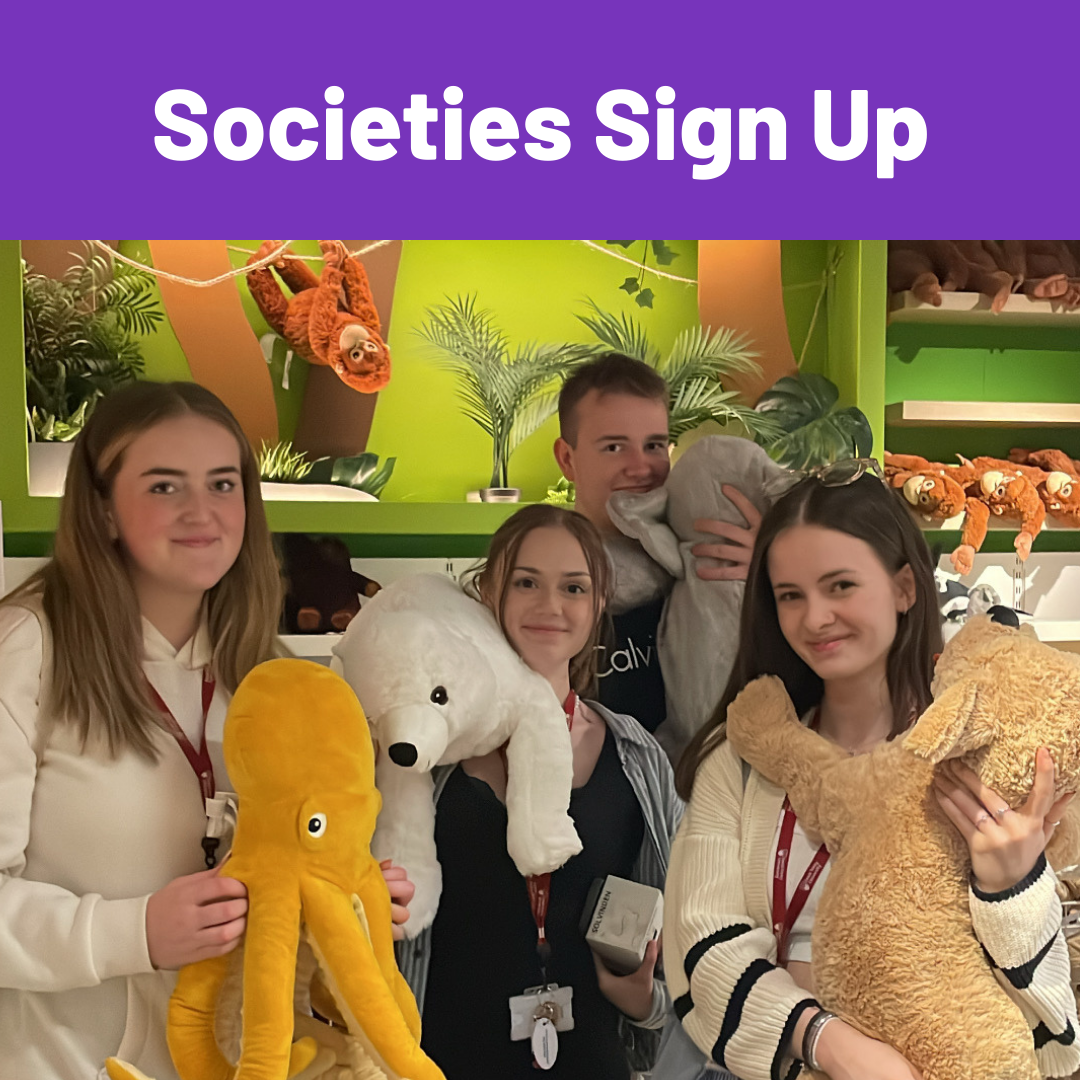 Image of people sitting around, conversing with each other whilst eating food.